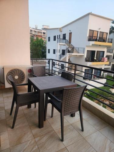 a table and chairs on top of a balcony at Stunning 2 Bedroom App at Relax Complex in Bijilo