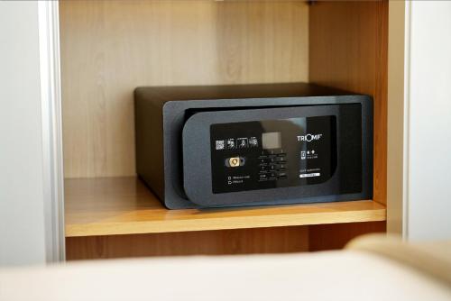 a small microwave sitting on a shelf in a room at Arc La Rambla in Barcelona