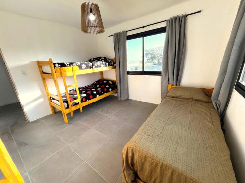a small bedroom with a bed and a window at Alquiler Mar del Plata Casa en Acantilados in Mar del Plata