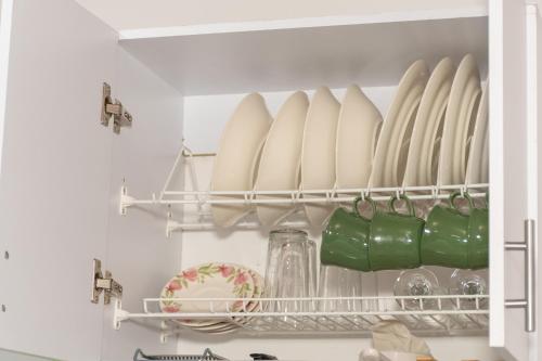 a refrigerator filled with plates and bowls and dishes at Home Sweet Home in Pitalito