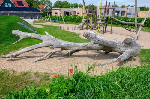 a statue of a fallen tree in a playground at Anpektop - Ecohuisjes Terschelling in Midsland