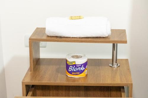 a can of peanut butter on a wooden shelf at Home Sweet Home in Pitalito