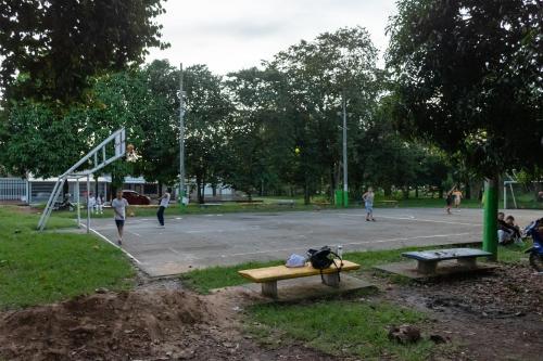 a park with two benches and a basketball court at Home Sweet Home in Pitalito
