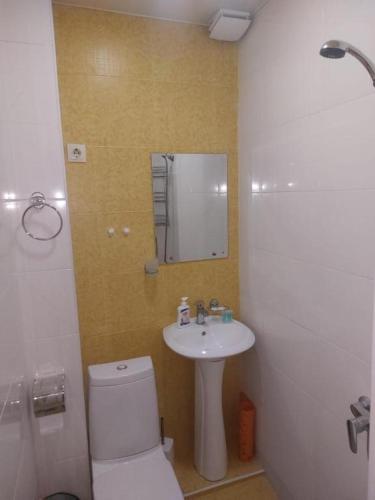 a bathroom with a white toilet and a sink at SWEETHOSTEL in Tbilisi City