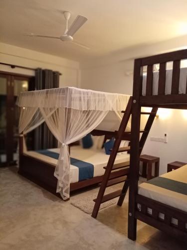 two bunk beds in a room with a ceiling at Green Grove in Matara