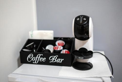 a coffeemaker and a coffee bar on a table at Home Joséphine - CASERTA in Caserta