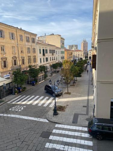 a city street with cars parked on the street at Mazzini House B&B in Sassari