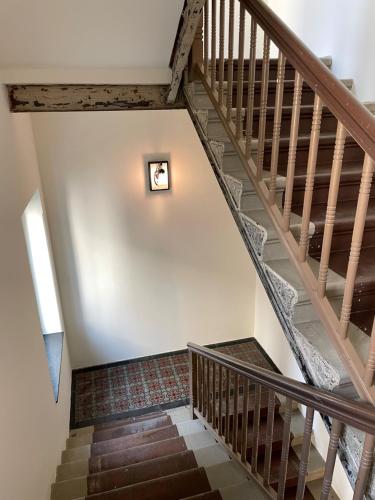 a staircase in a house with wooden railings at Ferienwohnung beethoven-12 in Zittau