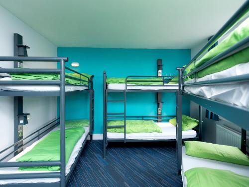 two bunk beds in a room with blue walls at YHA London Thameside in London