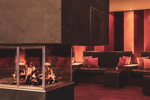 a living room with a fireplace and a couch at POP-UP LIVING Zell am See in Zell am See