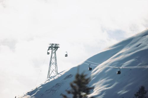 a ski lift on top of a snow covered mountain at POP-UP LIVING Zell am See in Zell am See