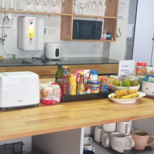 a counter top with food on it in a kitchen at Hello my friend in Bang Bua Thong Railway Station