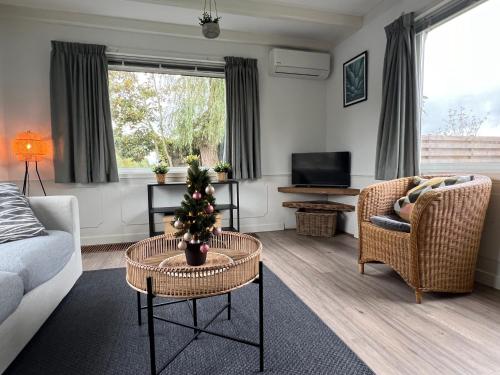 a living room with a christmas tree on a table at New- Private Cosy Houseboat, on a lake near Amsterdam in Vinkeveen