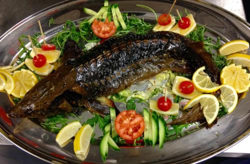 a plate of food with a fish on a salad at EA Hotel Atlantic Palace in Karlovy Vary