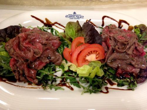 a plate of food with meat and vegetables on it at EA Hotel Atlantic Palace in Karlovy Vary