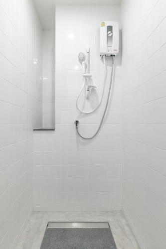 a white bathroom with a shower with a shower at Hello my friend in Bang Bua Thong Railway Station