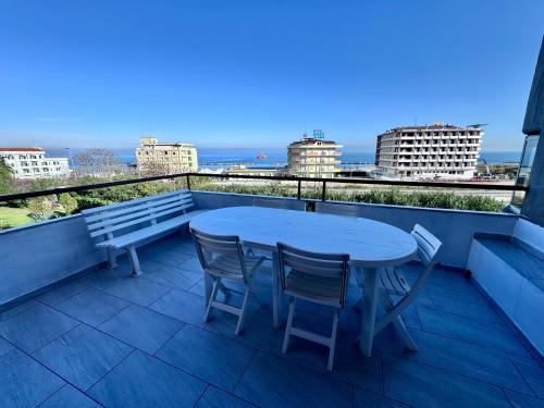 a table and chairs on a balcony with a view of the ocean at Le paperelle in Ortona