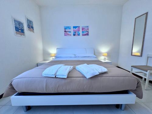 a bedroom with a large bed with two pillows at Le paperelle in Ortona
