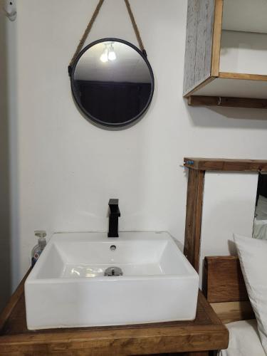 a bathroom with a white sink and a mirror at The International House Hostel in Quebec City