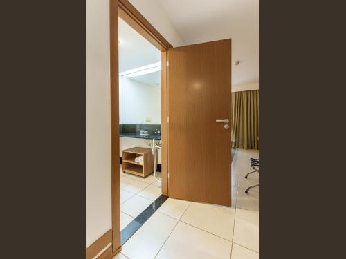 a door leading into a room with a desk at Athos Bulcão Hplus Executive in Brasilia