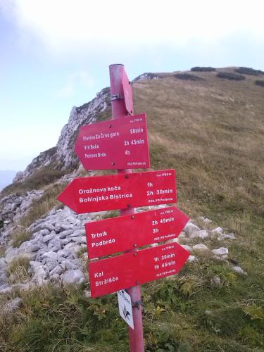 a red sign on the side of a mountain at Apartments Tubej in Bohinj