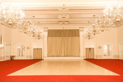 a large room with chandeliers and a red dance floor at Adelphi Hotel in Liverpool