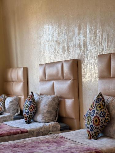 a bedroom with two beds with pillows on them at Dar bennis 2 in Rabat