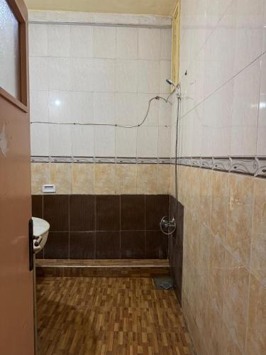 a bathroom with a shower with a toilet and a sink at Dar bennis 2 in Rabat