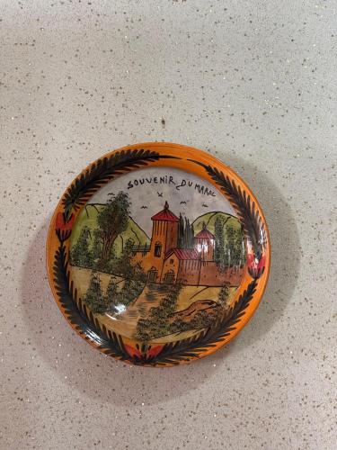 a bowl with a picture of a house on it at Dar bennis 2 in Rabat