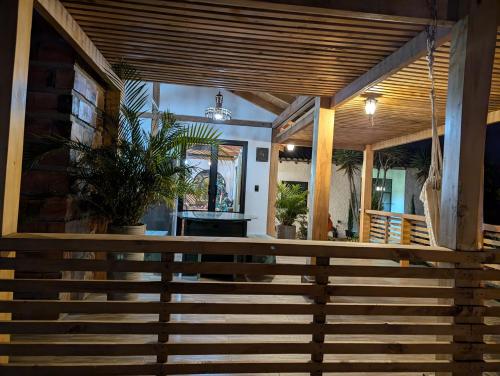 a porch with a wooden railing and stairs at Quinta Paolita in Tumbabiro