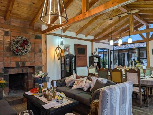 a living room with a couch and a fireplace at Quinta Paolita in Tumbabiro