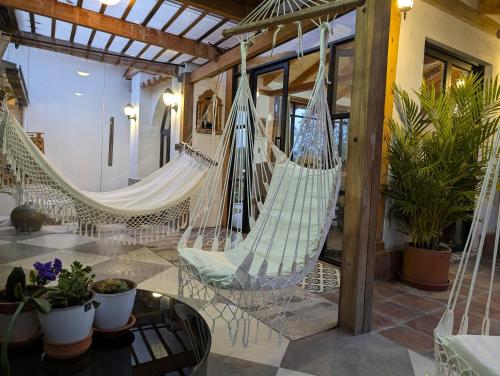 a room with two hammocks in a house at Quinta Paolita in Tumbabiro