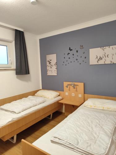 a room with two beds and a window at Apartment Morgengruß - Pool & Sauna in Hohegeiß