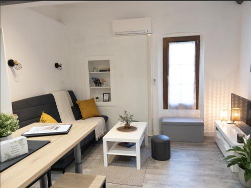 a living room with a couch and a table at La Parenthèse Cozy - À 2 min Basilique & Centre in Saint-Maximin-la-Sainte-Baume