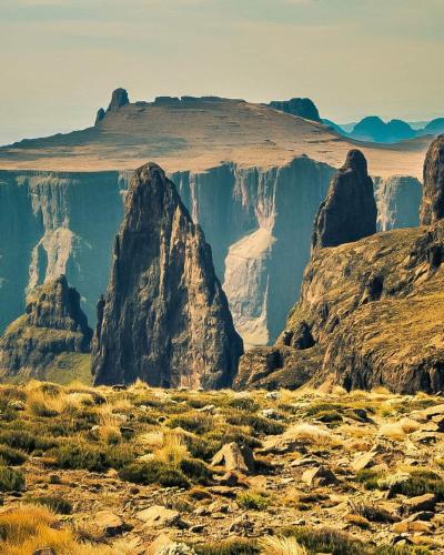 a view of a canyon with rocks and grass at Chikanka in Himeville