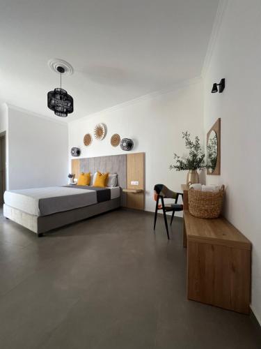 a bedroom with a bed and a table in a room at Cactus in Skiathos Town