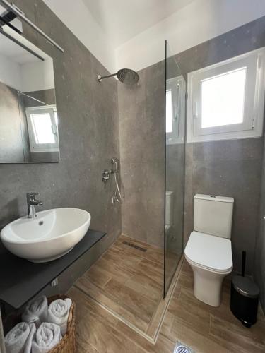 a bathroom with a sink and a toilet and a shower at Cactus in Skiathos Town