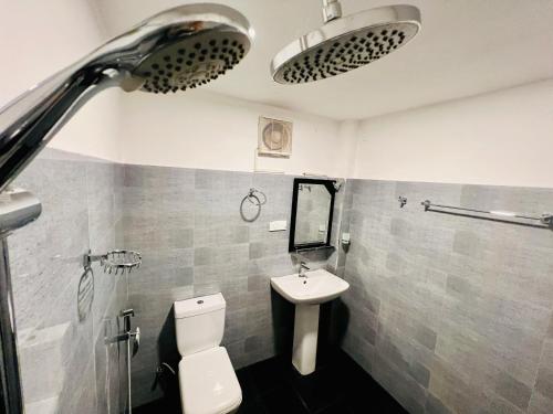 a bathroom with a toilet and a sink at Lagoon House - Hiriketiya in Dickwella