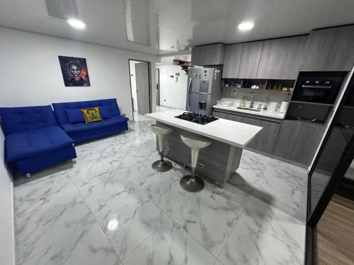 a kitchen with a blue couch and a counter top at Mirador Alacala in Envigado
