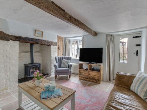 a living room with a couch and a fireplace at Amy Cottage in Wareham