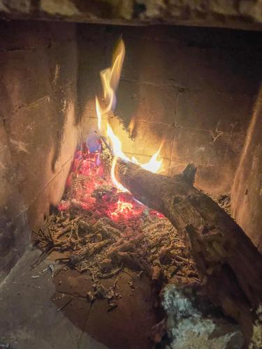 a fire in a brick oven with flames in it at tifrit maison d'hôtes-Paradise valley in Imouzzer des Ida Ou Tanane
