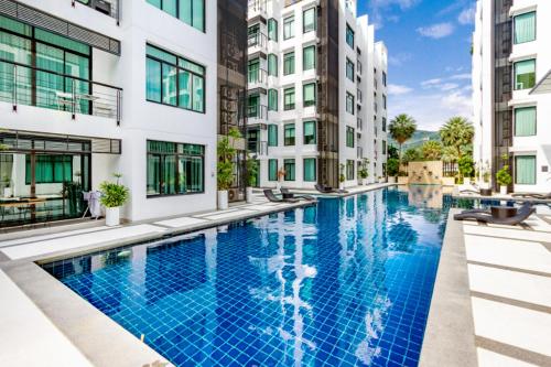 a swimming pool in the middle of a building at Luxury Two bedroom private swimming pool townhouse , Walk 800 meters to Kamala Beach in Phuket Town