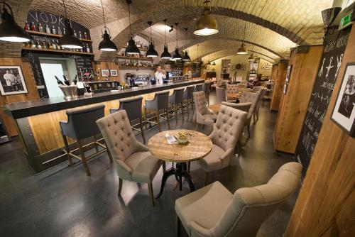 a restaurant with a table and chairs and a bar at Wilson Palace by LOFT in Bratislava