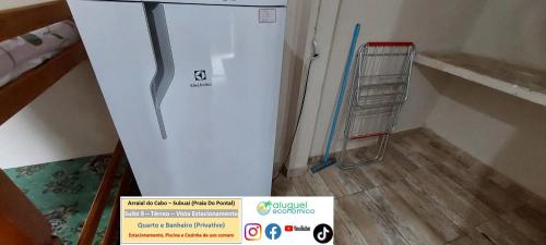 a white refrigerator in a room with a ladder at Arraial do Cabo – Subuai Village - Aluguel Econômico in Arraial do Cabo