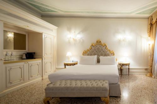 a bedroom with a bed and two tables with lamps at Ca' Bonfadini Historic Experience in Venice