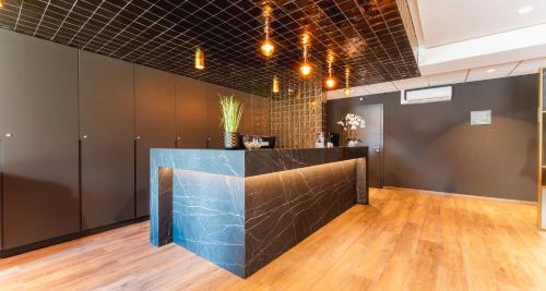 a bar in a room with wood floors at PLAZA INN Recklinghausen in Recklinghausen