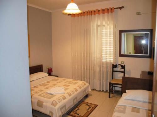 Postel nebo postele na pokoji v ubytování Grand Hotel