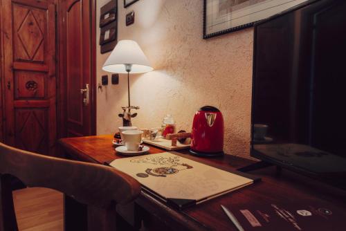 a table with a tea kettle and a cup on it at Villa Novecento Romantic Hotel - Estella Hotel Collection & Experience in Courmayeur