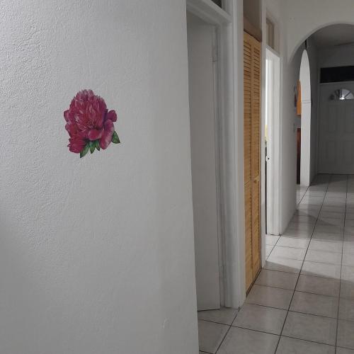 a flower on a wall in a hallway at Abigail Diamond 2 bedroom apt Near Nanny Cay marina in Hannah