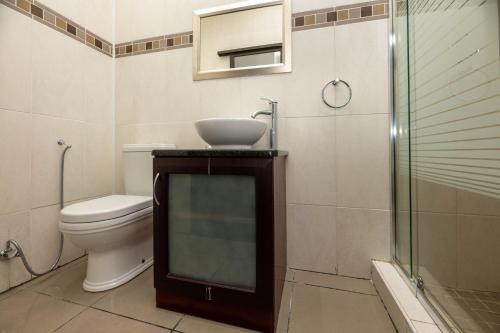 a bathroom with a toilet and a sink and a shower at Villa D este in Kimberley